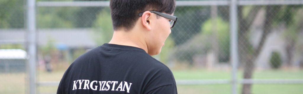 Azat wearing a t-shirt that says "Kyrgyzstan"