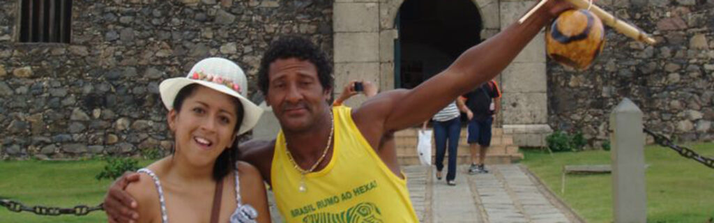 Connie takes a moment to pose with a Brazilian man in front of a historic structure.