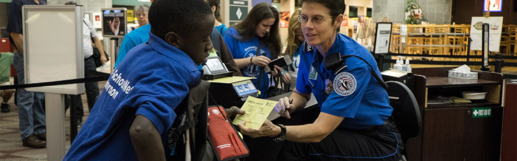 TSA checking in African student using crutches