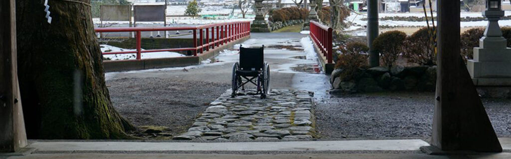 Empty wheelchair outside Asian temple