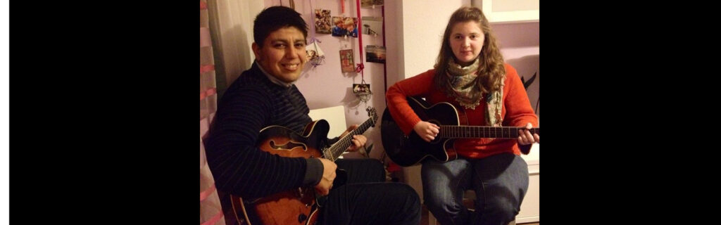 Erinn sitting next to a local Spanish man taking guitar lessons from him.