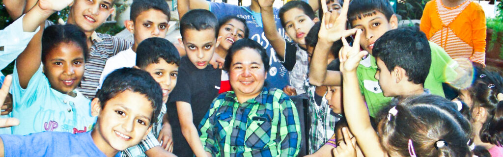 A volunteer surrounded by kids