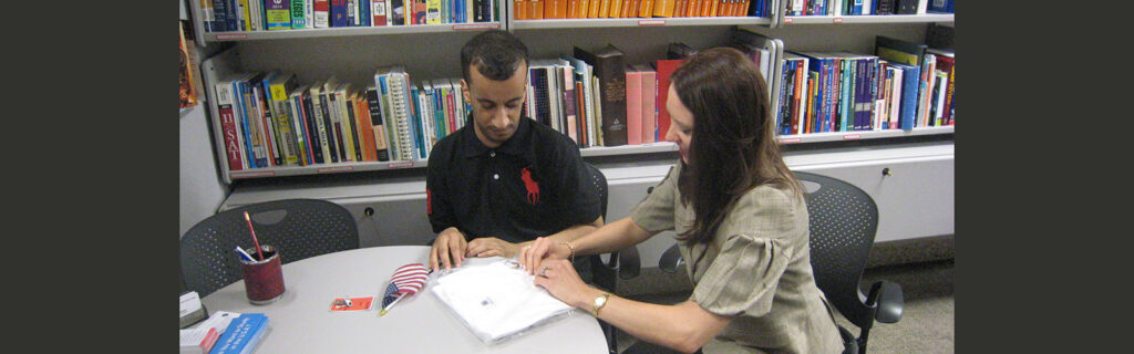 Karen Bauer (Right) reviewing documents with AR (Left) in a library.