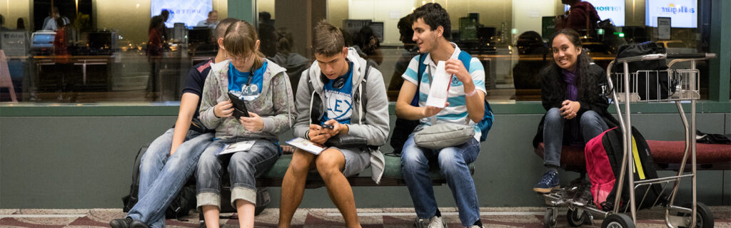 Four students waiting at the airport