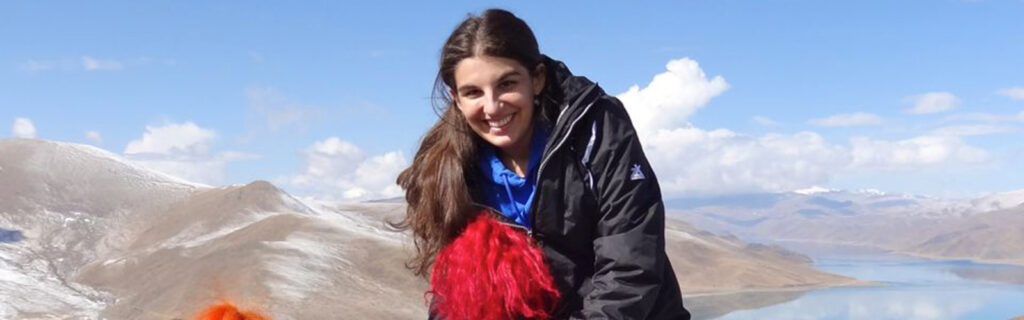 Emily Block Semester at Sea participant with chronic health condition rides a yak high in the mountains