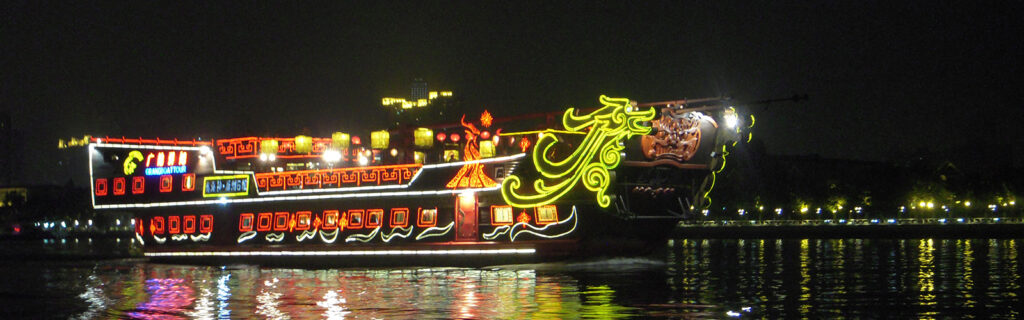 hero image - chinese boat lit in neon lights