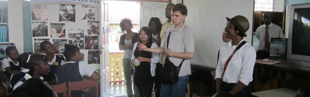 A young American man with autism presents to a classroom of Jamaican children.