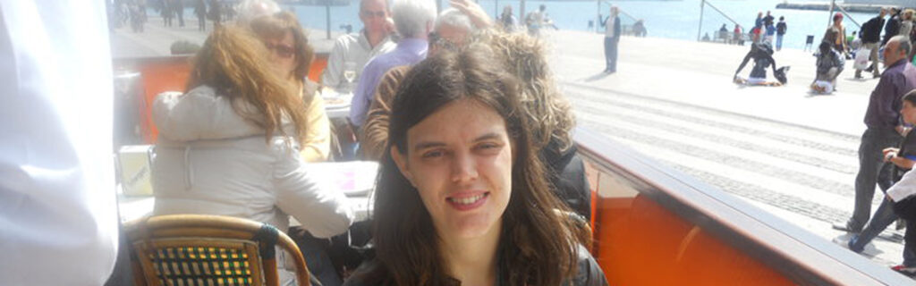 A young American woman dines at an outdoor restaurant.