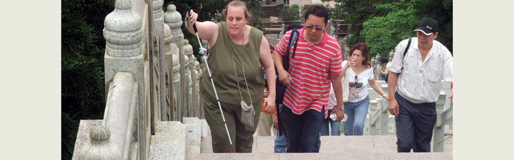 Christi Gilson, who is a blind American, explores Hong Kong with cane and local friend