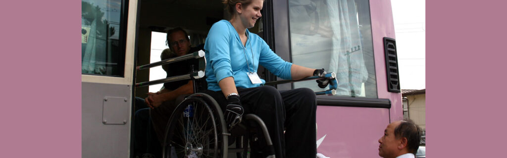 Wheelchair user on a lift from a bus