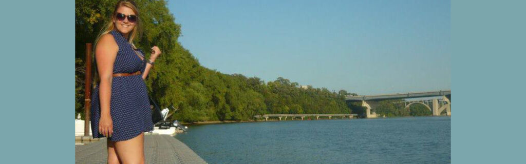 Portia stands by the river at her U.S. campus