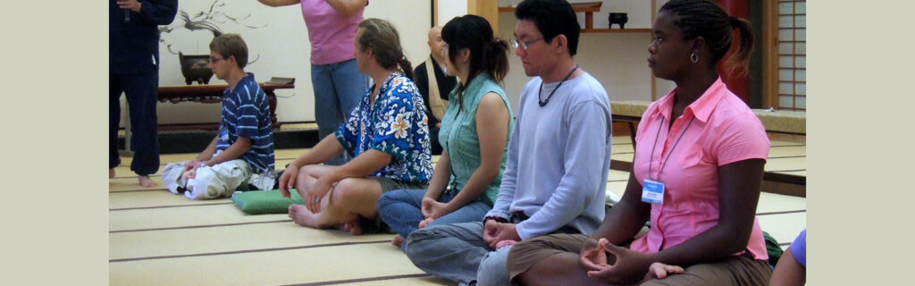 Line of exchange participants practicing sitting meditation