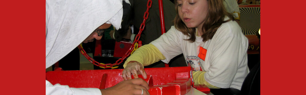 Two people focused on an activity on the table between them