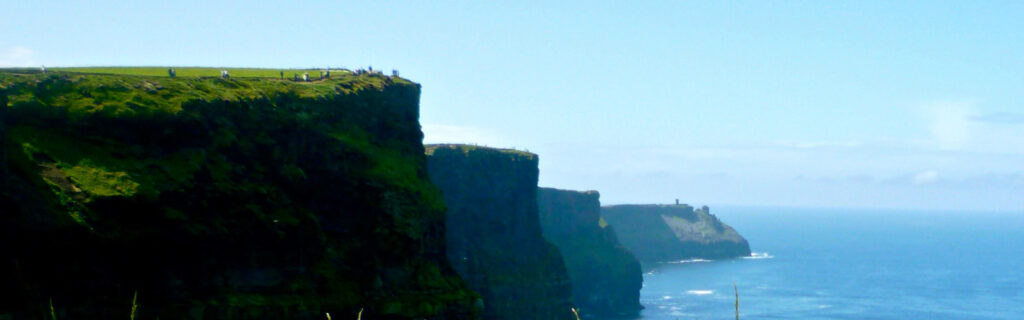 The steep cliffs of Ireland fade away to the sea