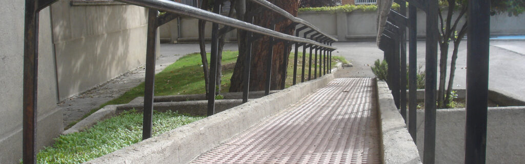 Low slope ramp with double handrails and tactile surface