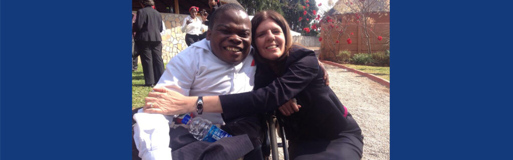 Rebecca hugging a Zimbabwean student who is a wheelchair user.