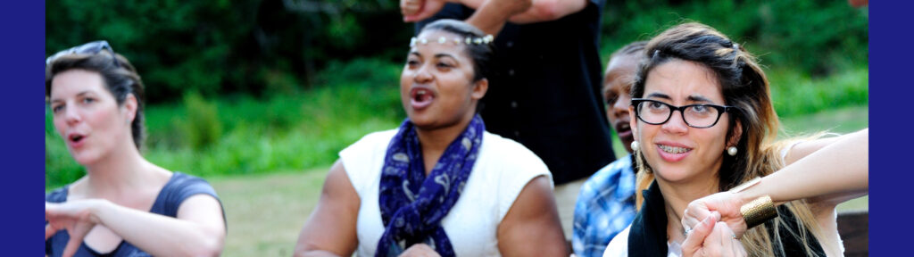 three women singing and signing in sign language along to the lyrics