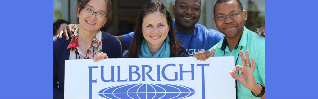 Men and women holding a sign with Fulbright logo