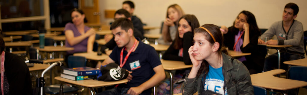 Students in a classroom listening to a presentation