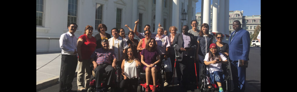 People pose for a group photo outside the White House during their tour of the East Wing