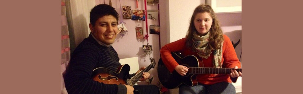 Erinn sitting next to a local Spanish man taking guitar lessons from him.