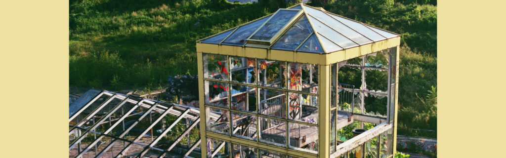 Tall greenhouse-like structure with a shallow pyramid roof