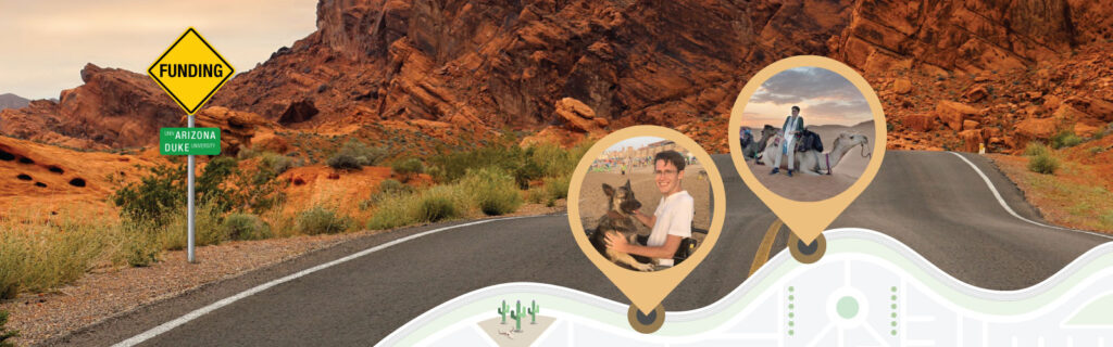 In the foreground graphic, a metal pole supports a yellow diamond-shaped road sign labeled “Funding” and below it, a green sign labeled “Univ Arizona, Duke University.” In the background photo, an inclining road with yellow double center lines rises towards reddish rocky hills below a hazy pink sky. Map markers show photo of a young white male student seated in a wheelchair with a dog in one and leaning against a camel in another