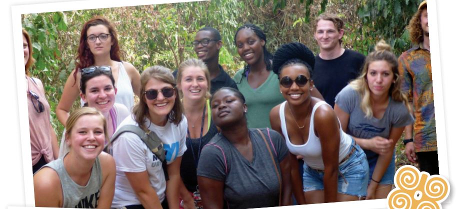 Group of a dozen young adults - men and women, people of color and white, and more - making glamorous or smiling poses in a jungle or forest setting