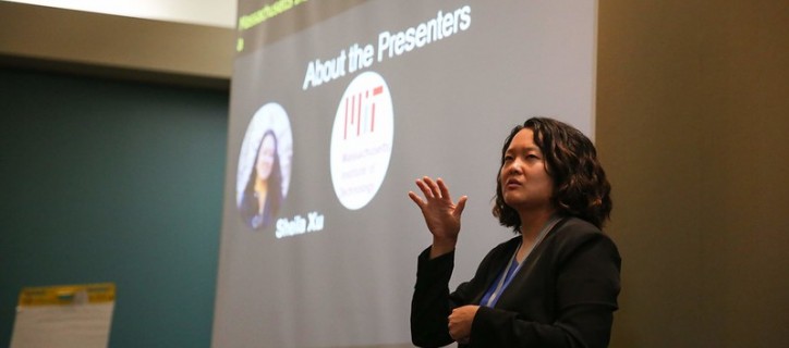 Sheila presenting in front of a screen