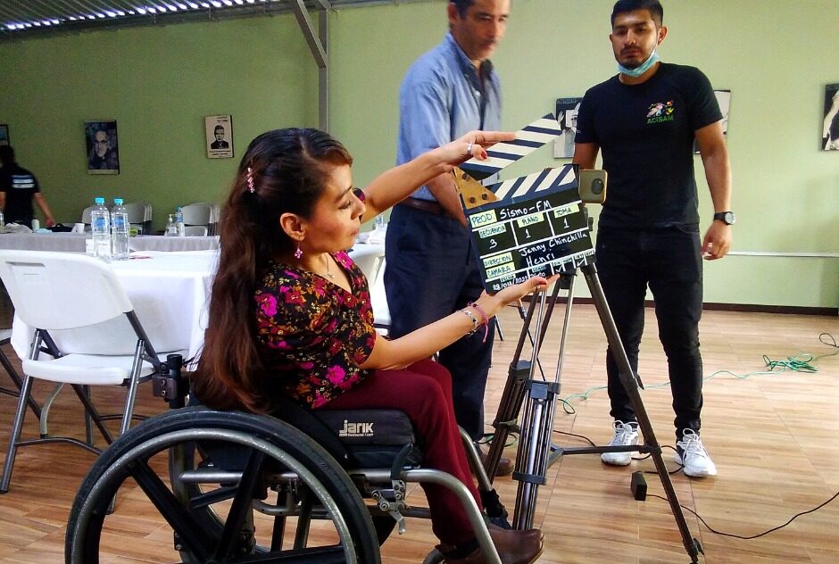 Jenny uses a clapperboard during the filming of her documentary.